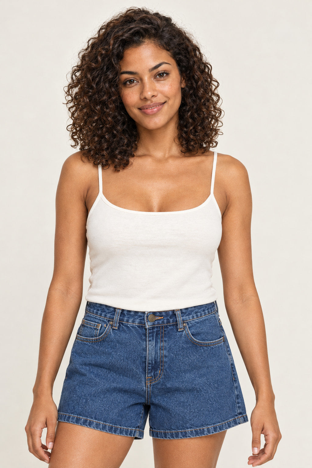 Jeans | Shorts Jeans Mom Alcance em azul jeans, vestido na modelo com regata branca, vista frontal